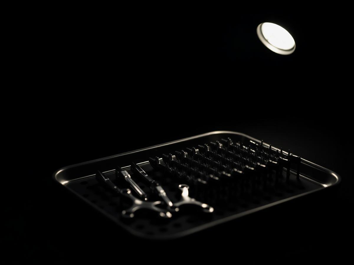 Professional piercing tools arranged on a black tray